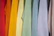 Close-up of colorful women's t-shirts hanging neatly on a rack
