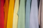 Close-up of colorful women's t-shirts hanging neatly on a rack