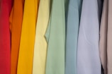 Rows of colorful cotton shirts hanging neatly on racks.