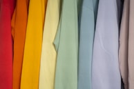 A row of vibrant men's shirts hanging neatly, highlighting the variety available at Haryana Vastralaya.