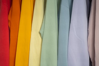 A row of colorful medical scrubs hanging neatly, highlighting the clean lines and quality stitching.