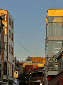 A vibrant Cairo street scene with modern apartments and traditional architecture blending under a clear blue sky.