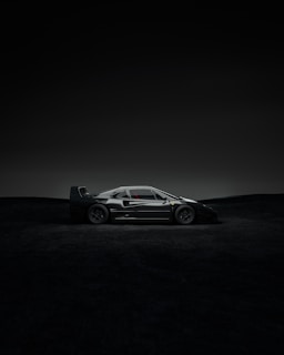 A Lamborghini poised like a predator, sharp angles catching the minimal light in the black space