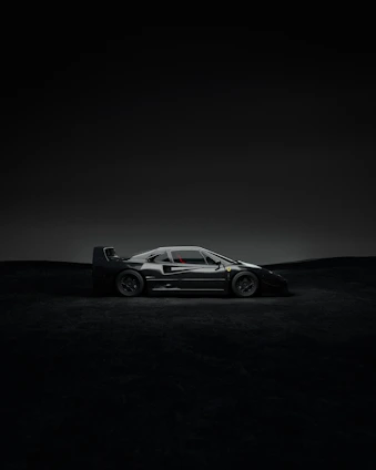 A sleek noirveloce car silhouette illuminated by cinematic lighting against a dark, minimalist backdrop.