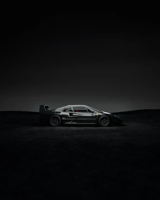Sleek black sports car under dramatic lighting showcasing nerštis design