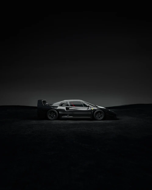 Sleek black sports car under dramatic lighting showcasing nerštis design