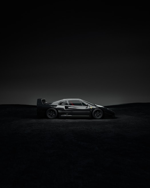A Lamborghini poised like a predator, sharp angles catching the minimal light in the black space