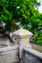 Close-up of a beautifully crafted stone pier cap on a garden fence.