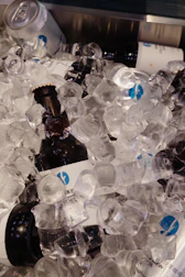 Event setup with coolers full of crystal-clear ice ready for drinks.