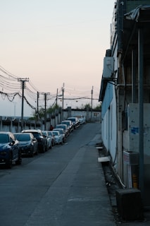 Workers collaborating in a well-maintained industrial street lined with clean roads and utility poles.