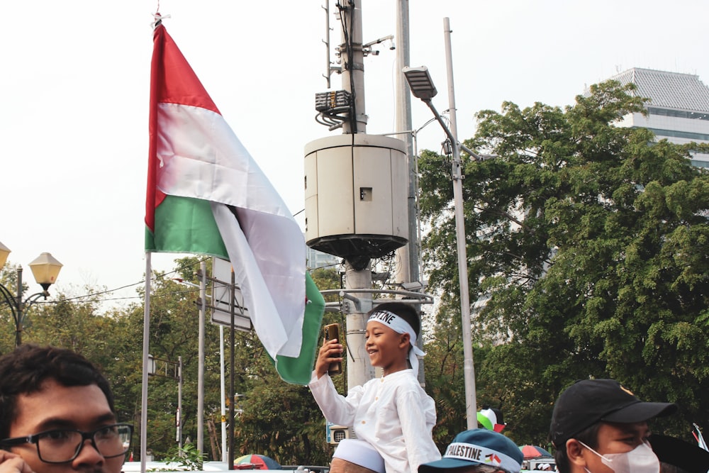 a group of people standing around a flag