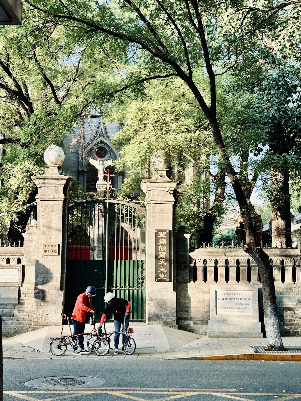 a couple of people riding bikes down a street