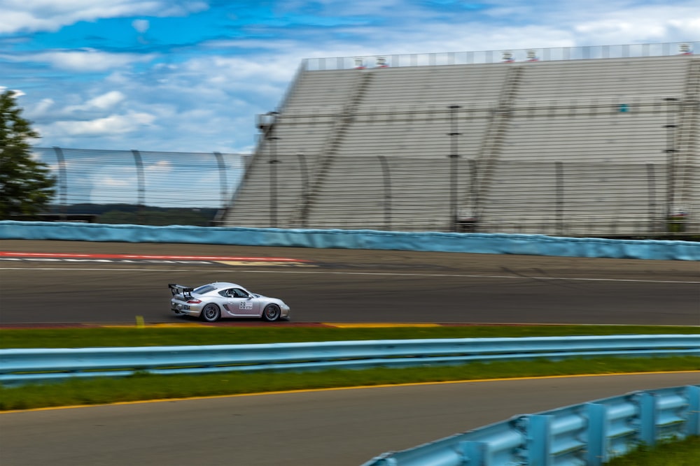 a small car driving down a race track