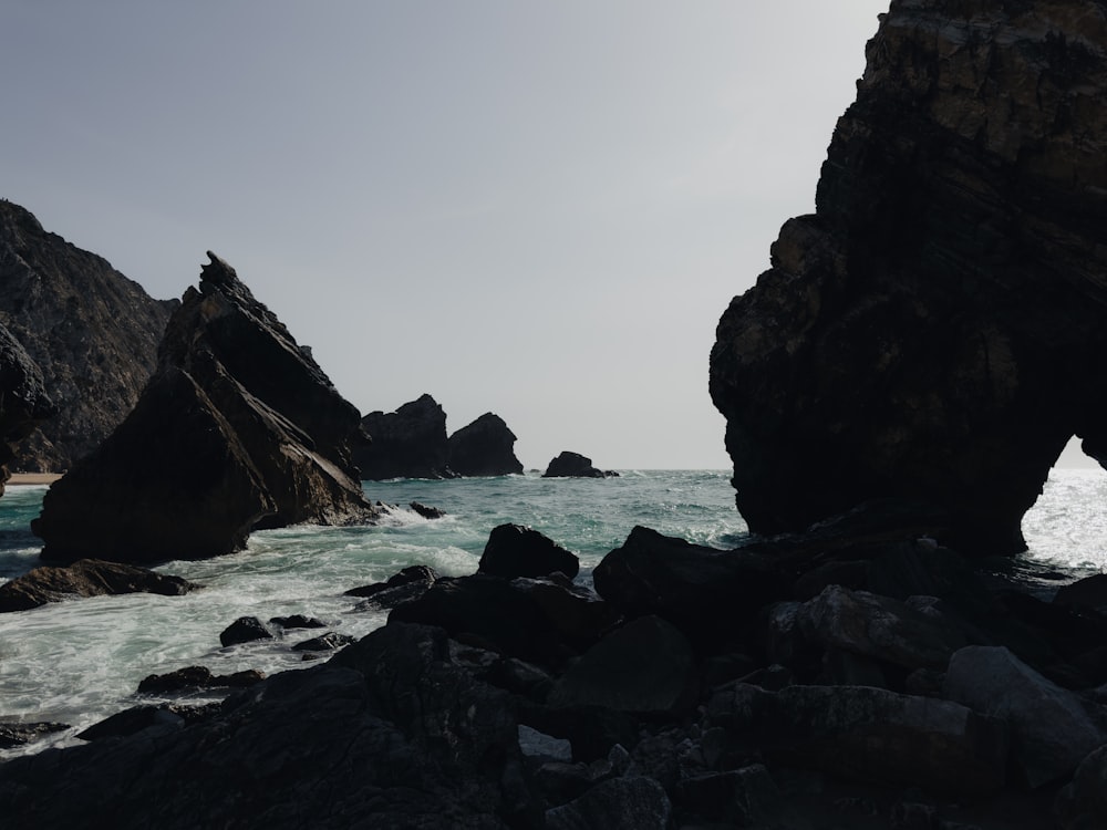 a large rock formation in the middle of a body of water