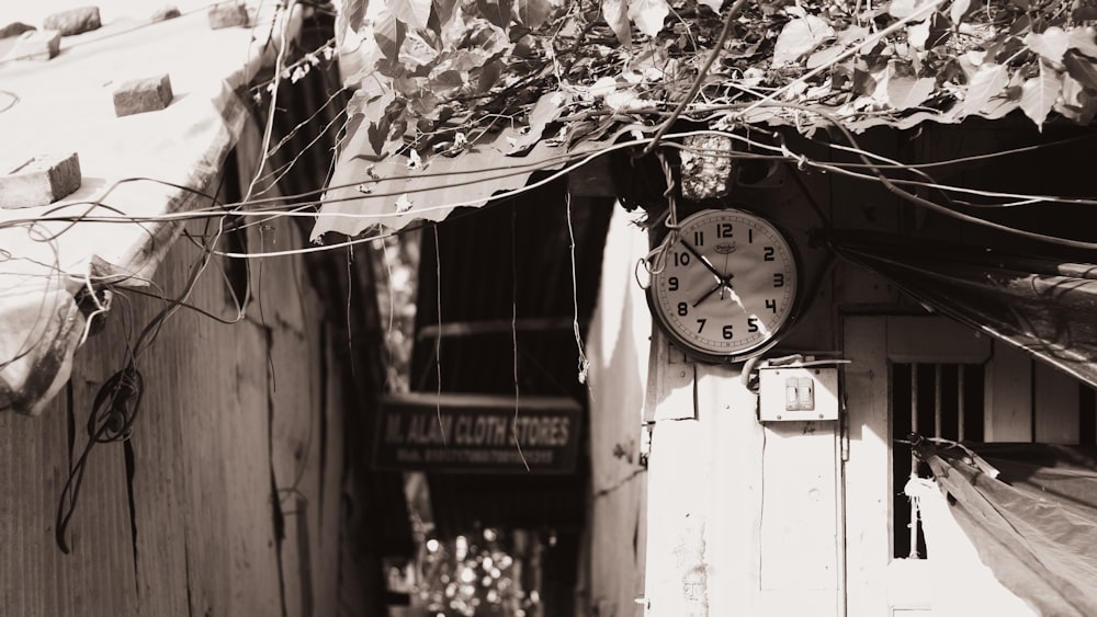 a black and white photo of a clock on a wall