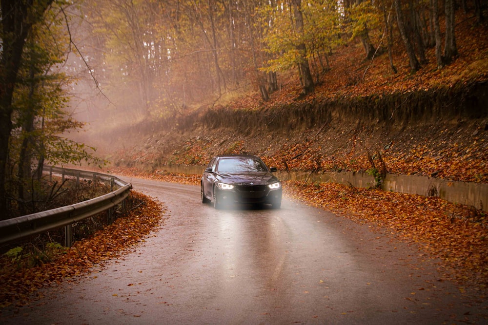 a car driving down a road in the rain