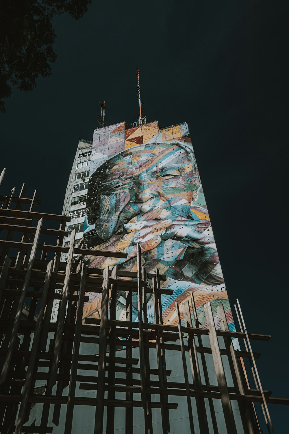 a tall building with a painting on the side of it