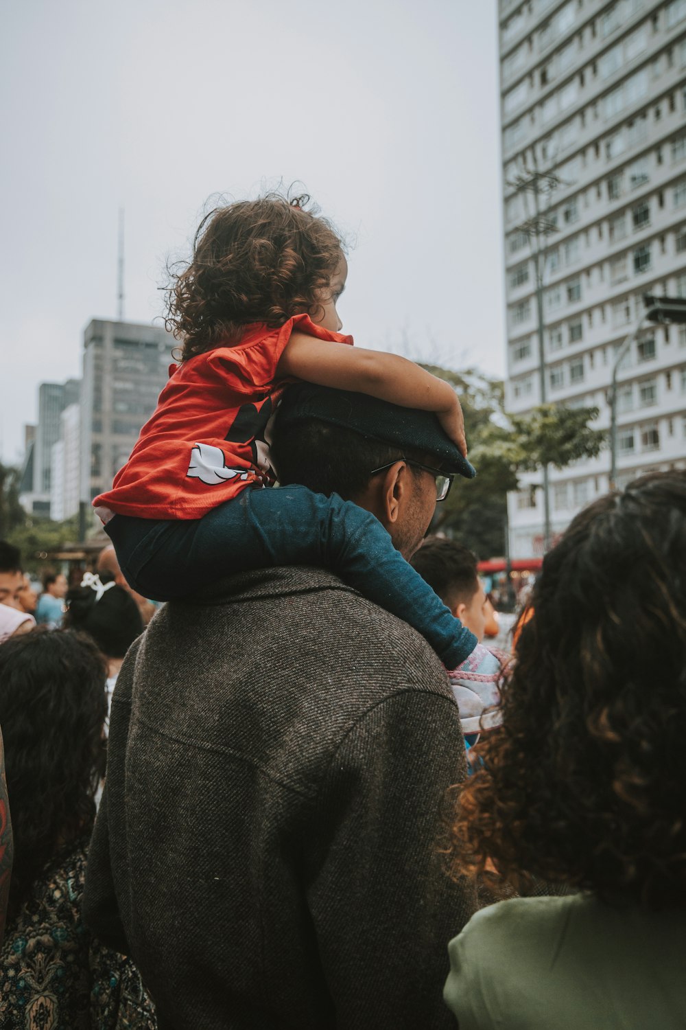 a man carrying a child on his shoulders