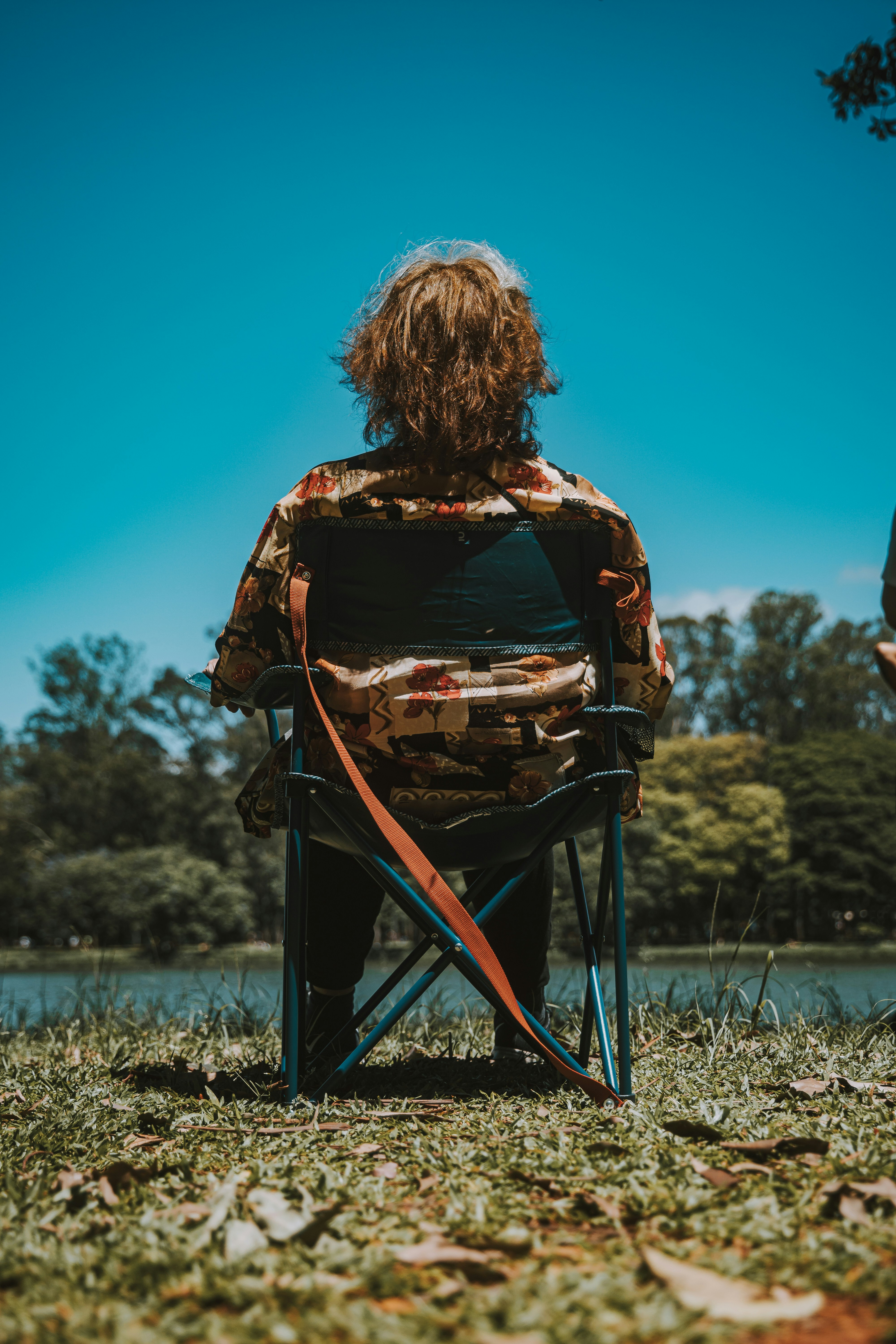 a person sitting in a chair in a field