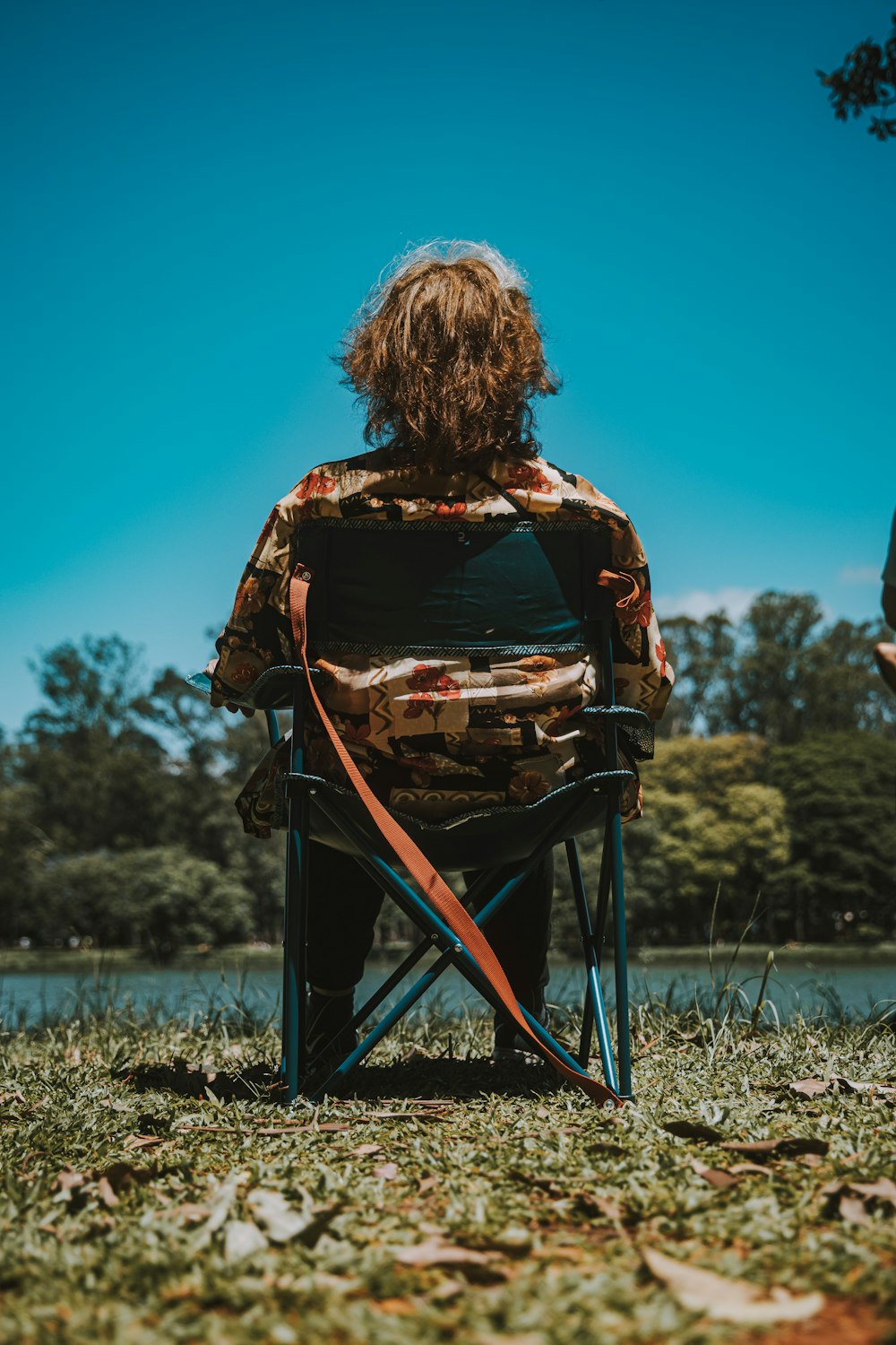 a person sitting in a chair in a field