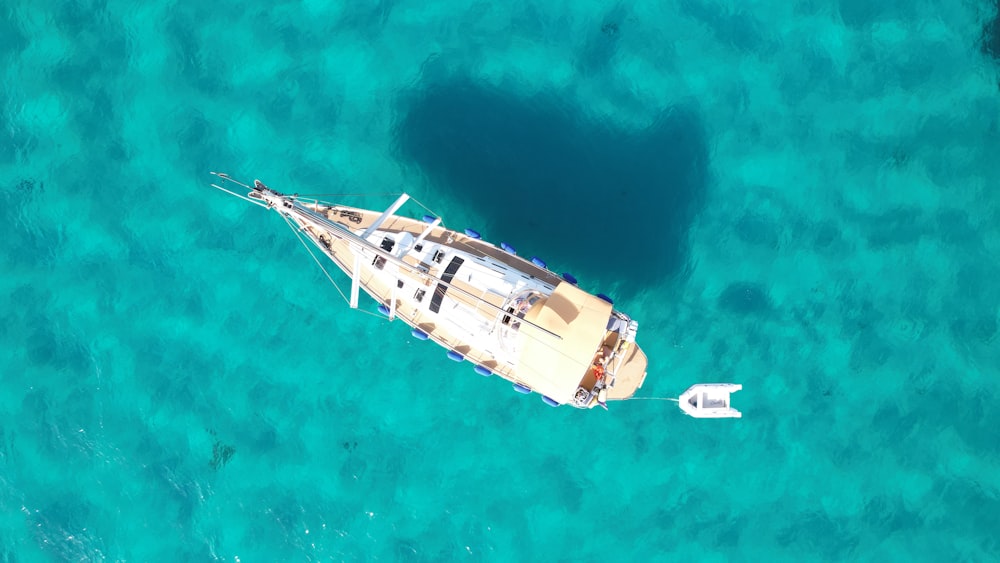 an aerial view of a boat in the ocean