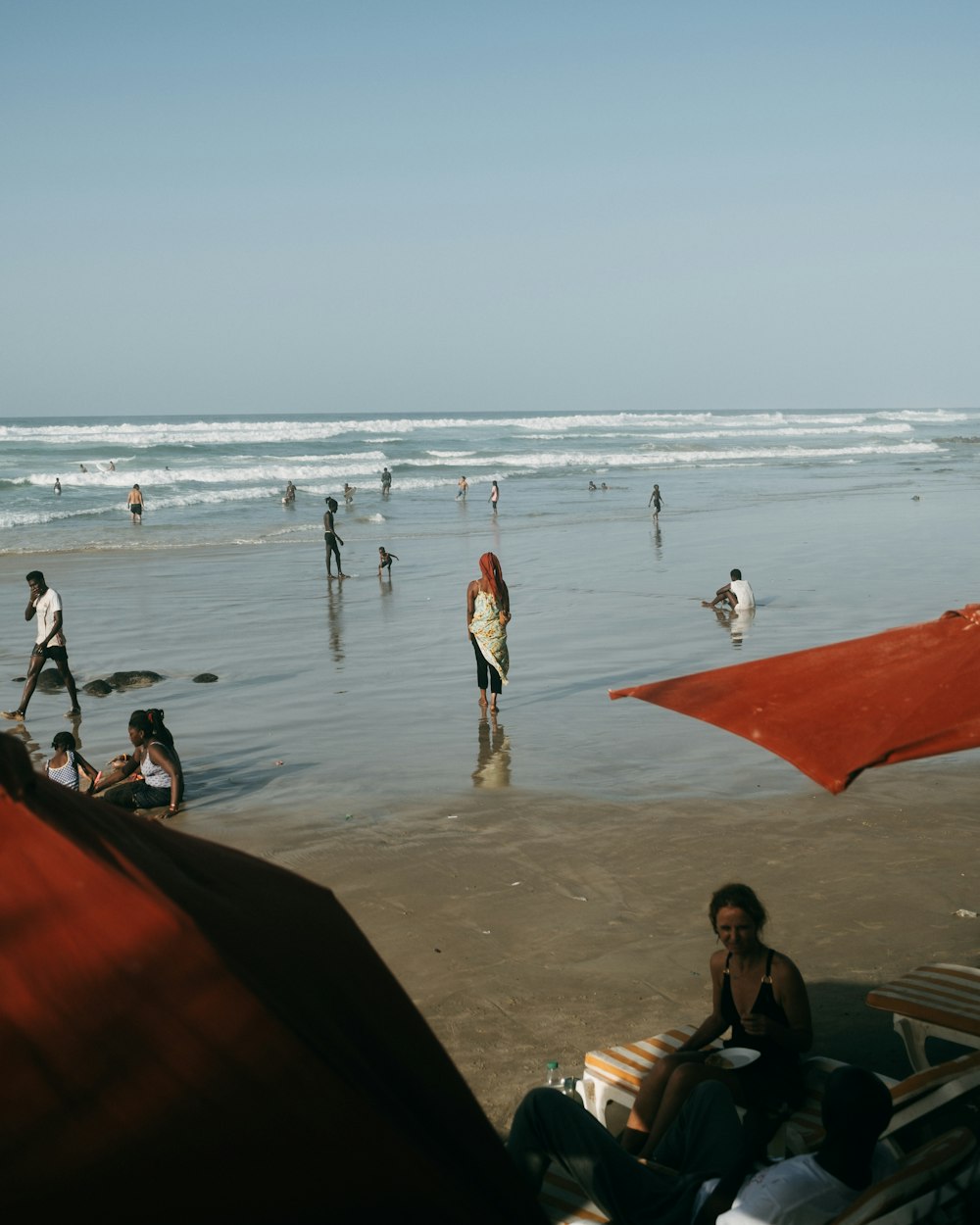 um grupo de pessoas em cima de uma praia ao lado do oceano