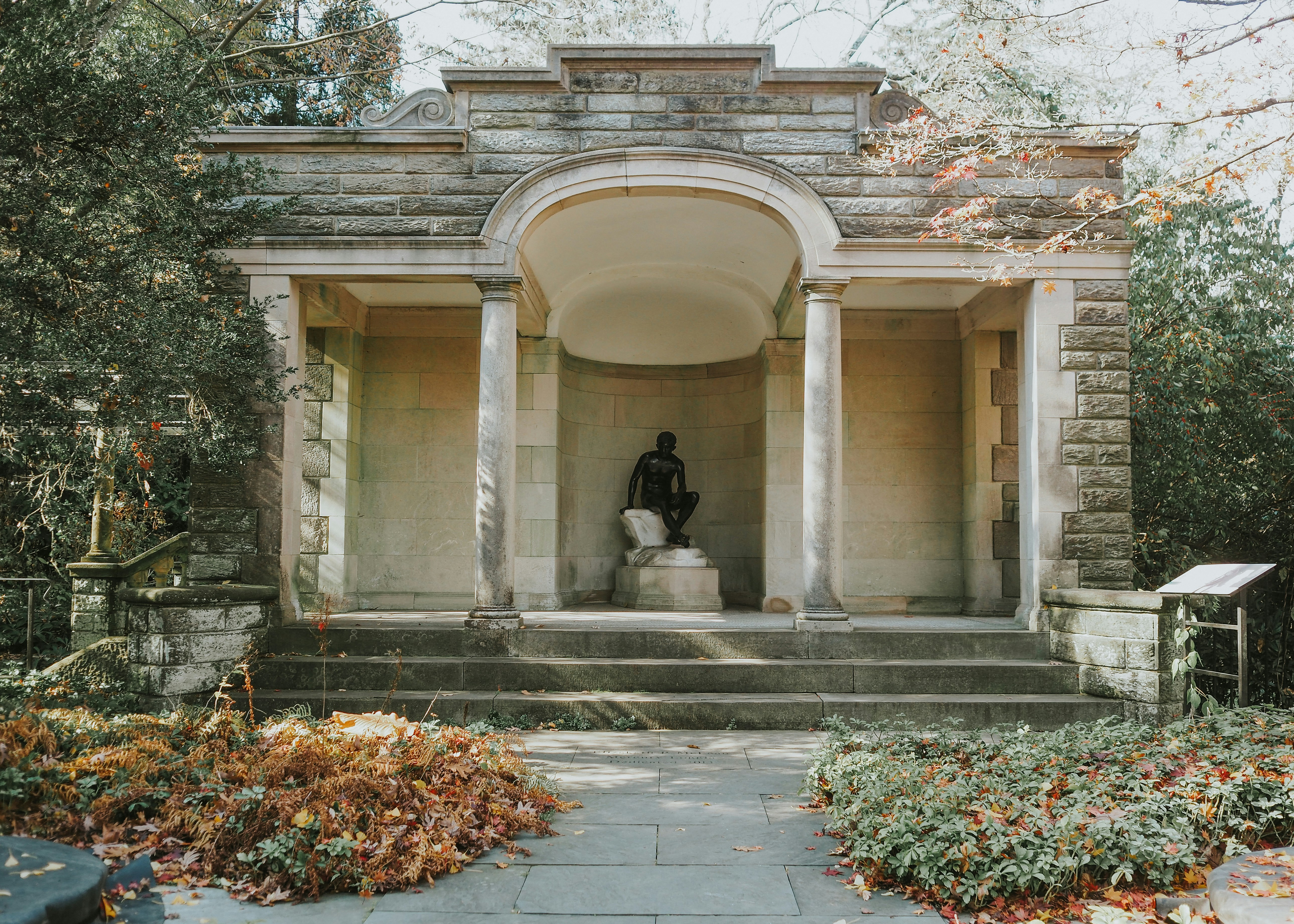 A man sitting on a bench in front of a building
