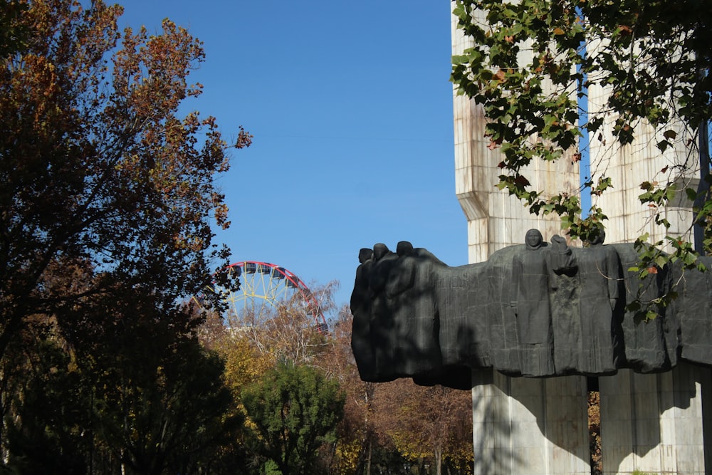 a statue of a bear in front of a tall building