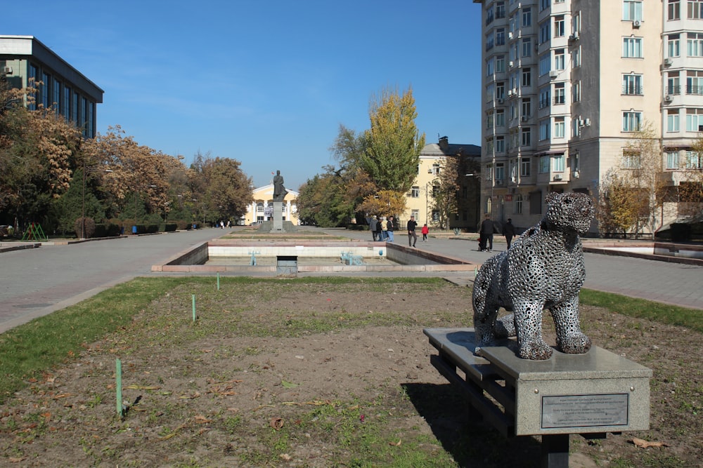 a statue of a leopard sitting on top of a bench