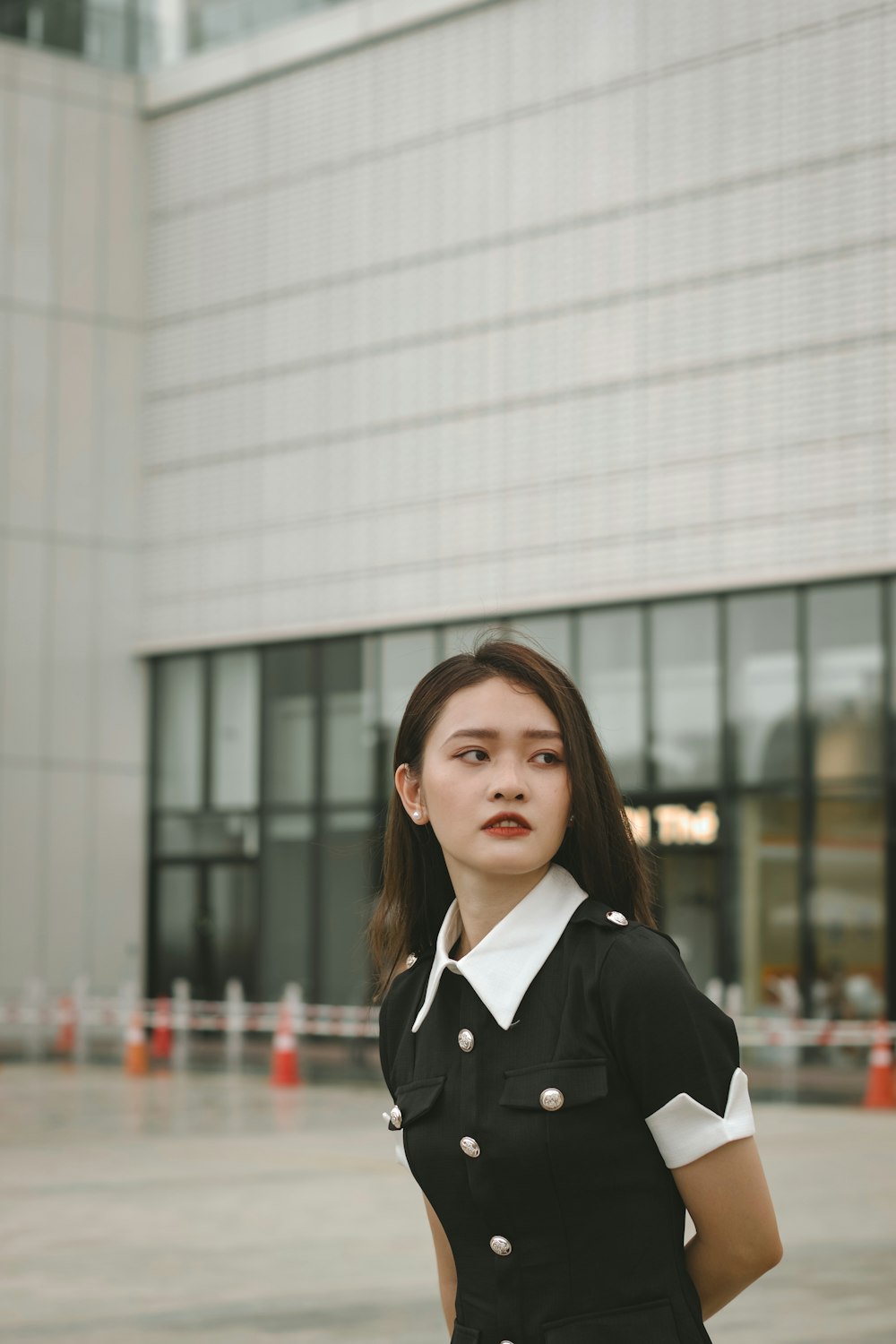 a woman standing in front of a building