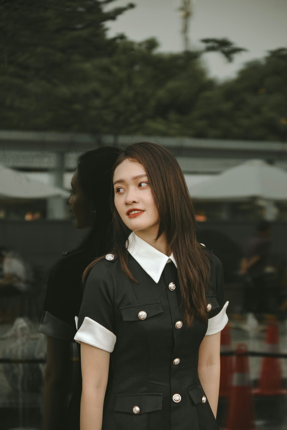 a woman in a uniform standing in front of a building