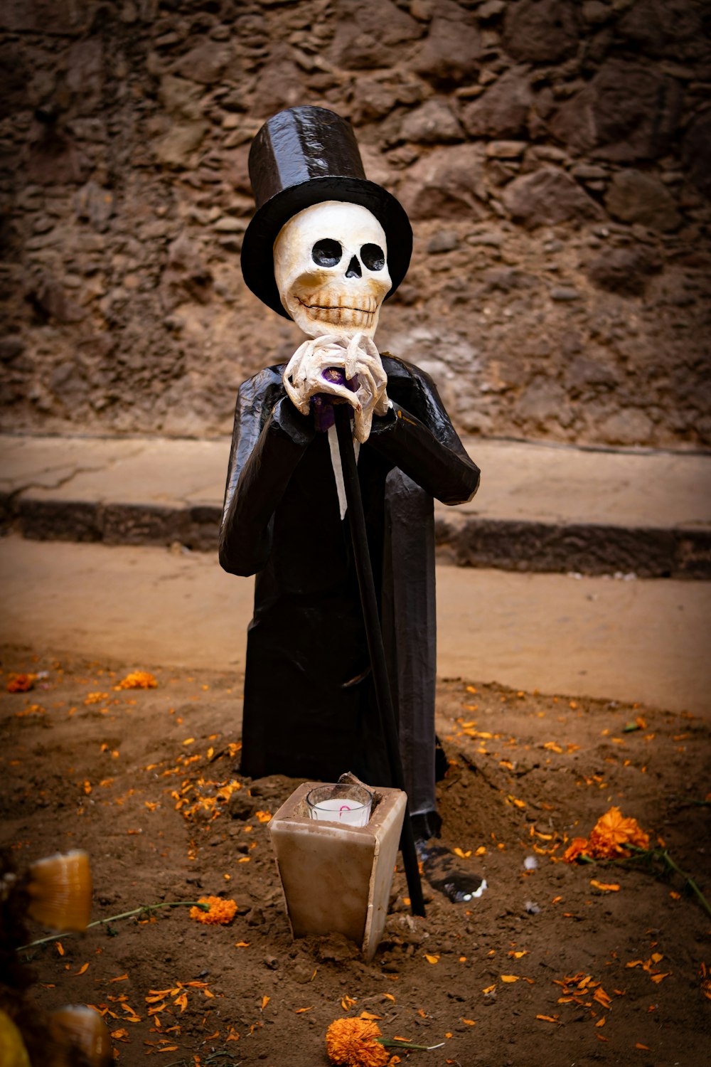 a skeleton with a top hat and a cane