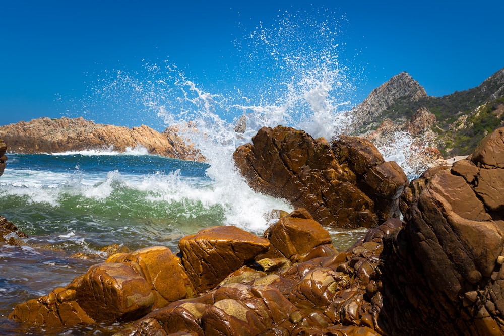 a rocky shore with waves crashing against the rocks