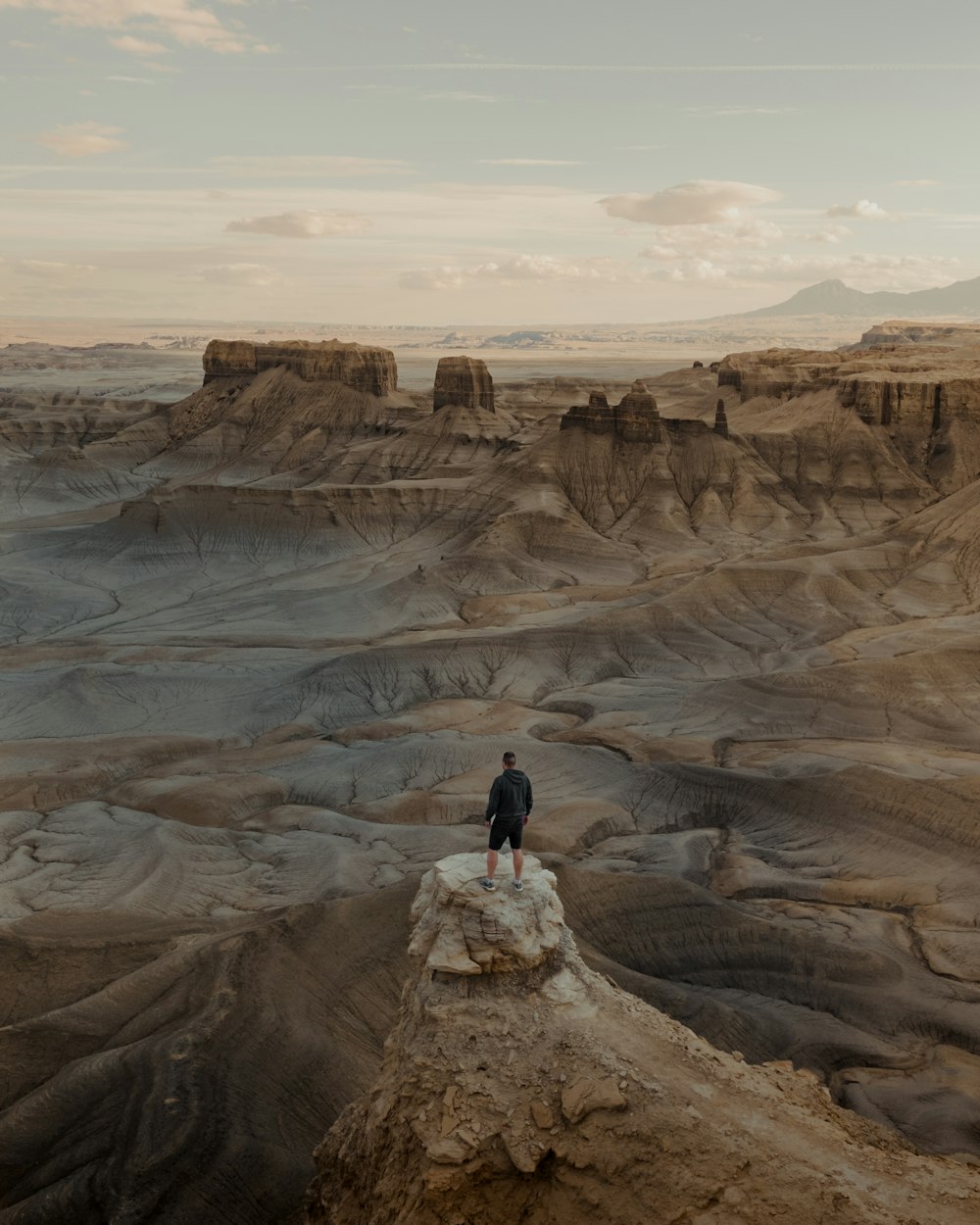 a man standing on top of a rock formation