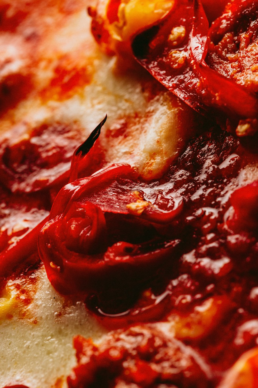 a close up of a pizza with red sauce on it