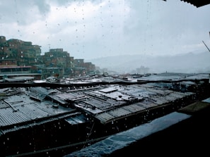 A dramatic Sims scene showing a character looking out a rainy window.