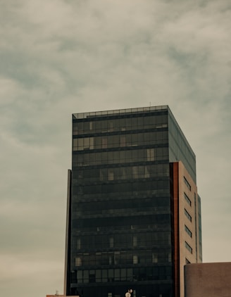 a tall black building sitting next to a tall building