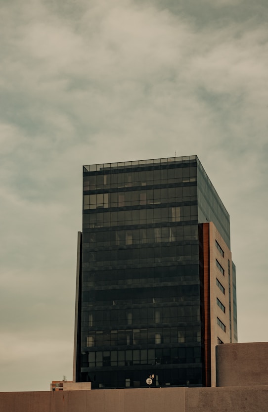 a tall black building sitting next to a tall building
