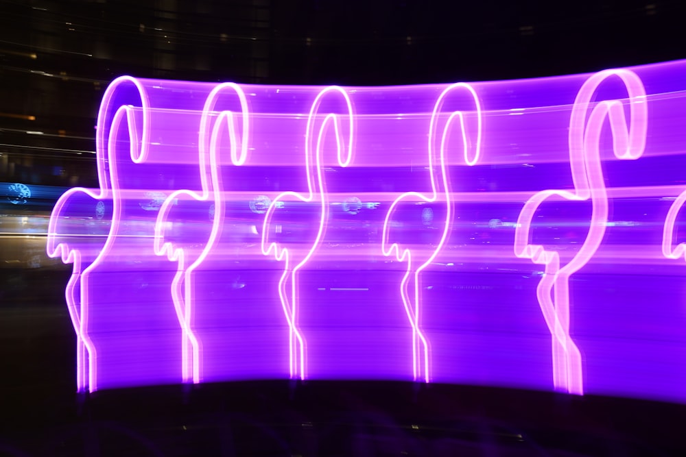 a large display of purple lights in a dark room