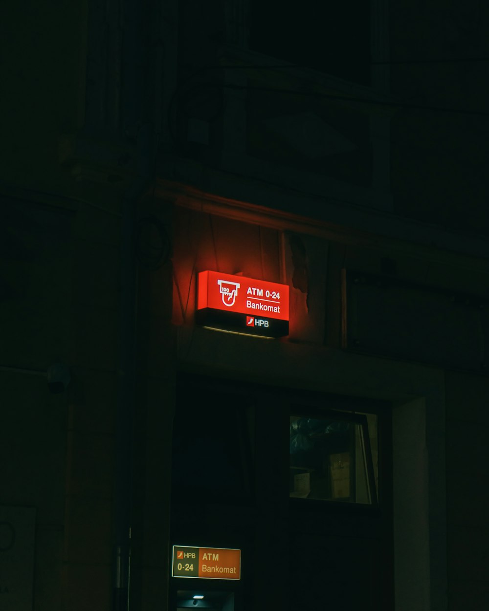 a red sign that is on the side of a building