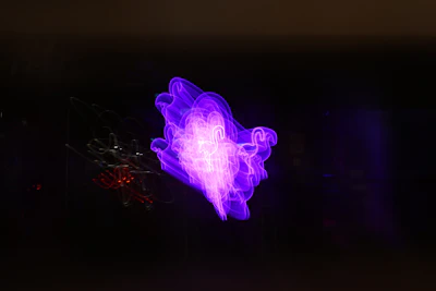 Abstract digital network lines glowing in purple and blue over a dark background.