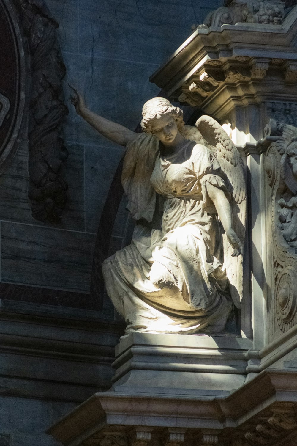 a statue of a woman holding a bird on top of a building