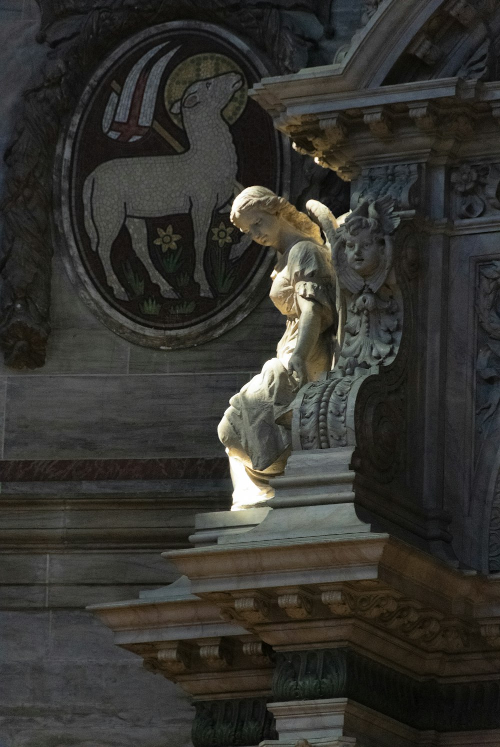 a statue of an angel on a pillar