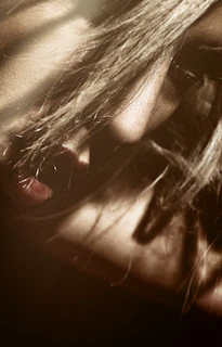 Close-up of a model’s playful glance through soft lighting for an intimate vibe.