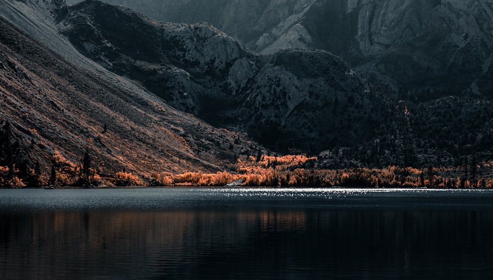 a mountain range with a lake in the foreground