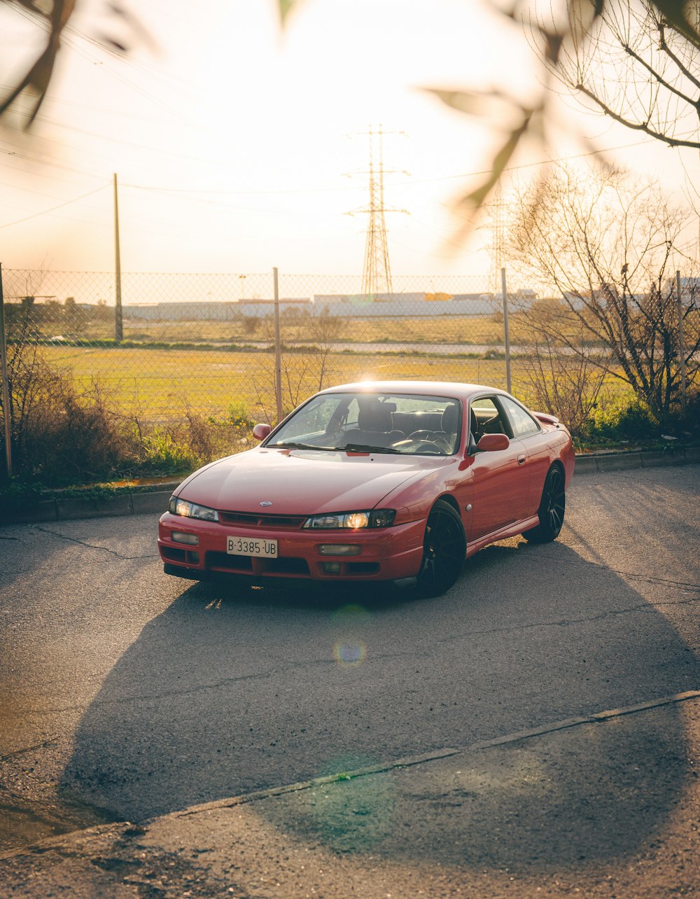 a red sports car parked in a parking lot