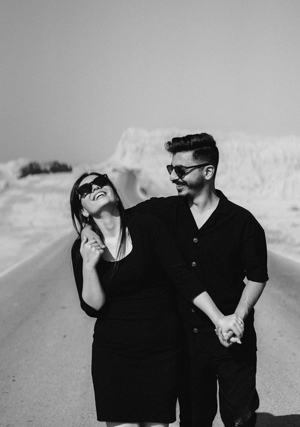 a man and a woman walking down a road