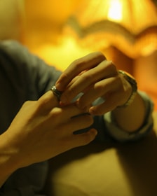 Close-up of hands gently adjusting objects in a cozy living room.