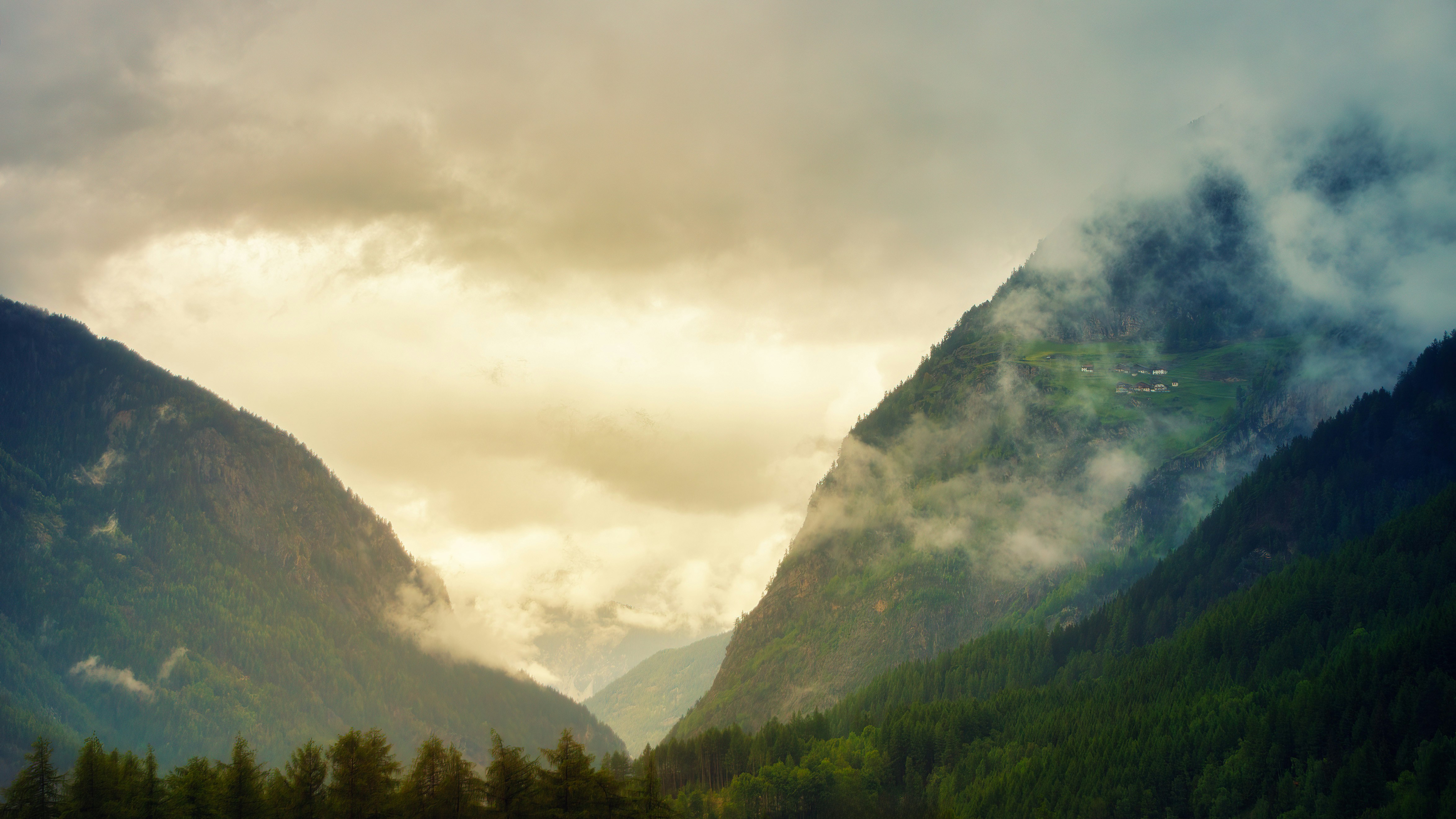 a view of a valley with mountains in the background