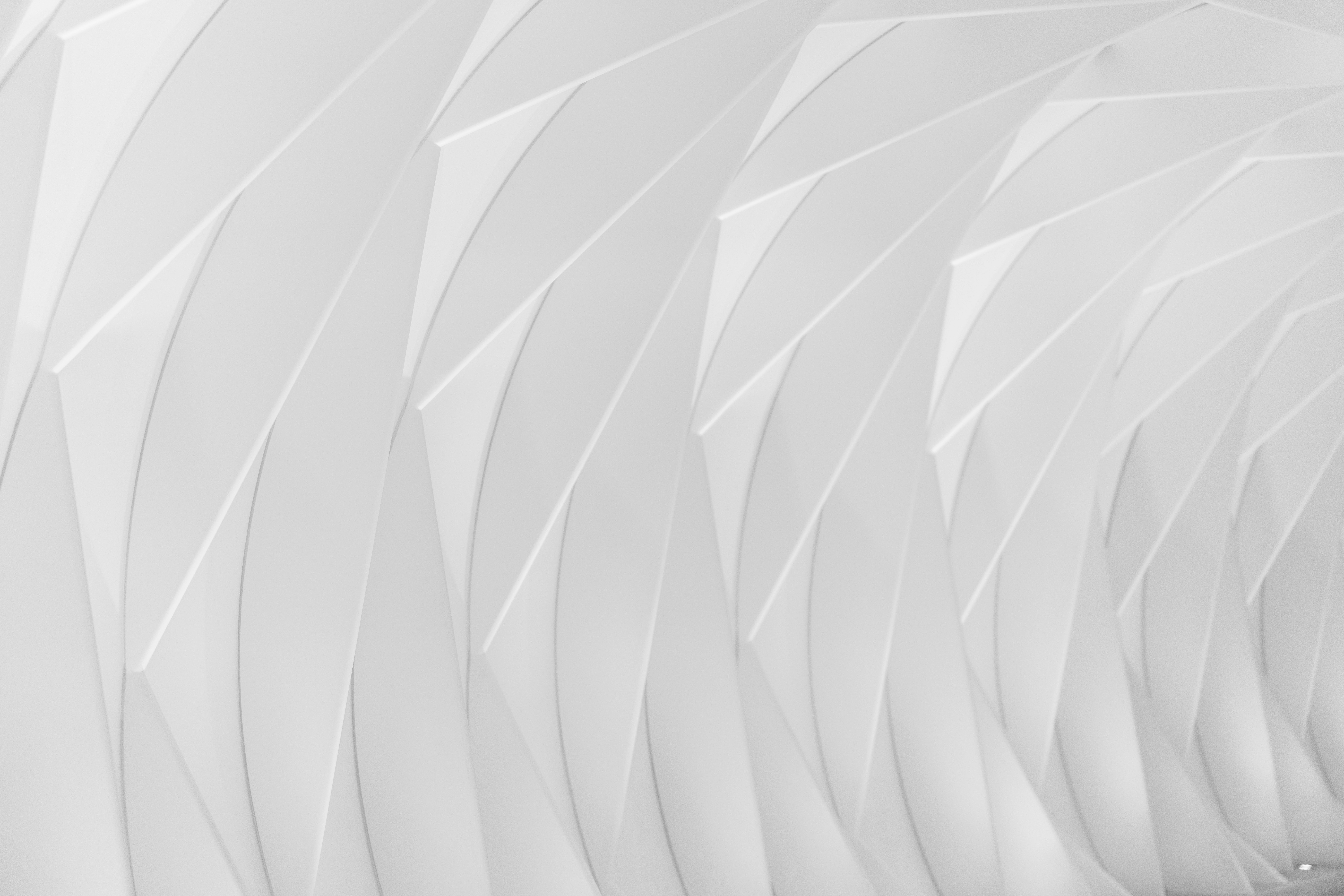 a black and white photo of a white wall